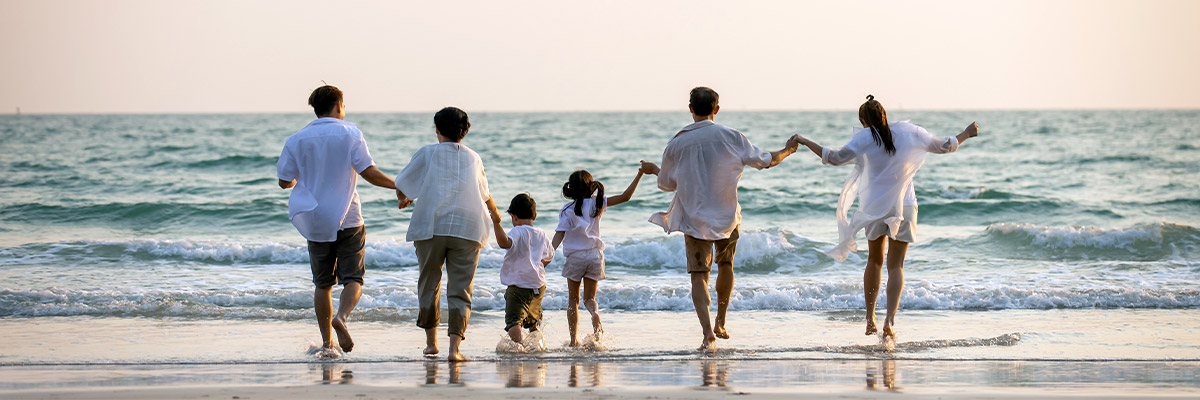 family on the beach holding hands at the shore safest place for retirement money