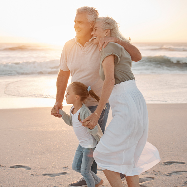 grandparents with granddaughter walking beach fixed indexed annuity faragi group delaware