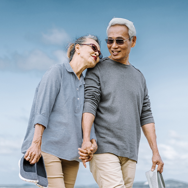 loving couple walking the beach together will you have enough to retire retirement faragi group delaware