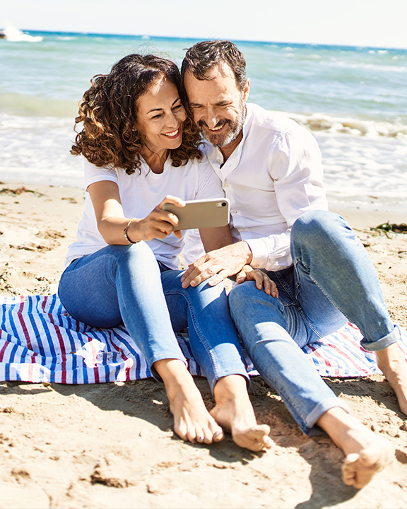 senior couple taking selfie on beach annuity benefits annuities faragi group delaware
